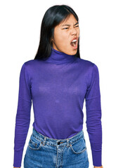 Sticker - Beautiful young asian woman wearing casual clothes angry and mad screaming frustrated and furious, shouting with anger. rage and aggressive concept.