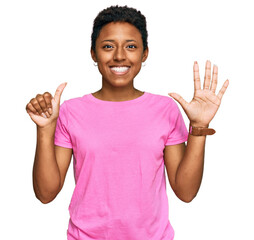 Wall Mural - Young african american woman wearing casual clothes showing and pointing up with fingers number six while smiling confident and happy.