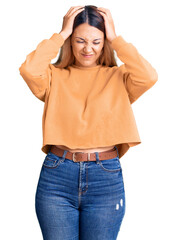 Canvas Print - Beautiful young woman wearing casual clothes suffering from headache desperate and stressed because pain and migraine. hands on head.