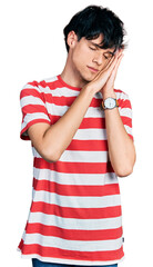 Poster - Handsome hipster young man wearing casual striped t shirt sleeping tired dreaming and posing with hands together while smiling with closed eyes.