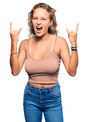 Wall Mural - Beautiful caucasian woman wearing casual clothes shouting with crazy expression doing rock symbol with hands up. music star. heavy concept.