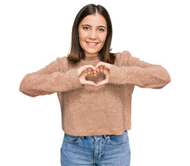 Sticker - Young beautiful woman wearing casual clothes smiling in love doing heart symbol shape with hands. romantic concept.