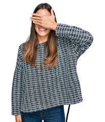 Canvas Print - Young beautiful woman wearing casual clothes smiling and laughing with hand on face covering eyes for surprise. blind concept.