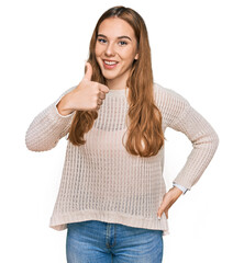 Sticker - Young blonde woman wearing casual clothes doing happy thumbs up gesture with hand. approving expression looking at the camera showing success.