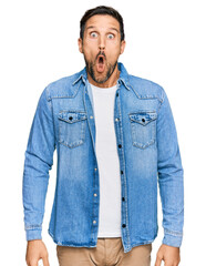 Sticker - Young handsome man wearing casual denim jacket afraid and shocked with surprise expression, fear and excited face.