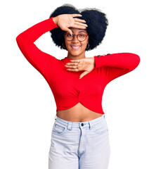 Sticker - Young african american girl wearing casual clothes and glasses smiling cheerful playing peek a boo with hands showing face. surprised and exited