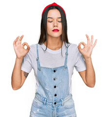 Wall Mural - Young hispanic girl wearing casual clothes relax and smiling with eyes closed doing meditation gesture with fingers. yoga concept.