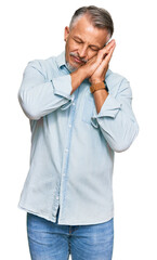 Sticker - Middle age grey-haired man wearing casual clothes sleeping tired dreaming and posing with hands together while smiling with closed eyes.