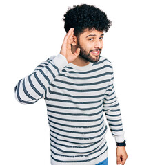 Canvas Print - Young arab man with beard wearing casual striped sweater smiling with hand over ear listening an hearing to rumor or gossip. deafness concept.