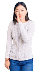 Sticker - Young beautiful chinese woman wearing casual sweater hand on mouth telling secret rumor, whispering malicious talk conversation