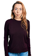 Poster - Young caucasian woman wearing casual clothes making fish face with lips, crazy and comical gesture. funny expression.