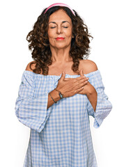 Canvas Print - Middle age hispanic woman wearing casual clothes smiling with hands on chest with closed eyes and grateful gesture on face. health concept.