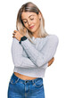 © Krakenimages.com - Beautiful blonde woman wearing casual clothes hugging oneself happy and positive, smiling confident. self love and self care