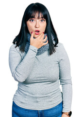 Sticker - Young hispanic plus size woman wearing winter scarf looking fascinated with disbelief, surprise and amazed expression with hands on chin