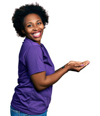 Poster - African american woman with afro hair wearing casual purple t shirt pointing aside with hands open palms showing copy space, presenting advertisement smiling excited happy