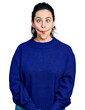 © Krakenimages.com - Young hispanic woman wearing casual clothes making fish face with lips, crazy and comical gesture. funny expression.