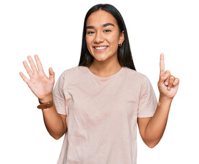 Poster - Young asian woman wearing casual clothes showing and pointing up with fingers number six while smiling confident and happy.