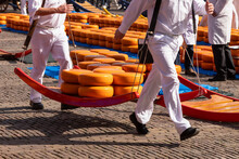 Cheese Carriers On The Cheese Market In The Dutch City Of Alkmaar.