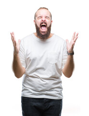 Sticker - Young caucasian hipster man wearing casual t-shirt over isolated background crazy and mad shouting and yelling with aggressive expression and arms raised. Frustration concept.