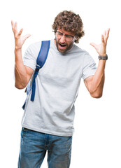 Wall Mural - Handsome hispanic student man wearing backpack and glasses over isolated background celebrating mad and crazy for success with arms raised and closed eyes screaming excited. Winner concept