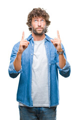 Poster - Handsome hispanic model man over isolated background amazed and surprised looking up and pointing with fingers and raised arms.