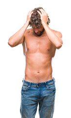 Wall Mural - Handsome hispanic model man sexy and shirtless over isolated background suffering from headache desperate and stressed because pain and migraine. Hands on head.