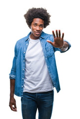 Poster - Afro american man over isolated background doing stop sing with palm of the hand. Warning expression with negative and serious gesture on the face.