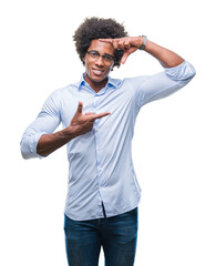 Wall Mural - Afro american business man wearing glasses over isolated background smiling making frame with hands and fingers with happy face. Creativity and photography concept.