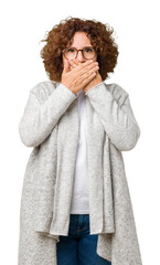 Poster - Beautiful middle ager senior woman wearing jacket and glasses over isolated background shocked covering mouth with hands for mistake. Secret concept.