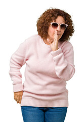 Poster - Beautiful middle ager senior woman wearing pink sweater and sunglasses over isolated background hand on mouth telling secret rumor, whispering malicious talk conversation