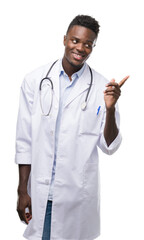 Sticker - Young african american man wearing doctor coat very happy pointing with hand and finger to the side