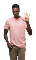 Poster - Young african american man wearing pink t-shirt showing and pointing up with fingers number five while smiling confident and happy.