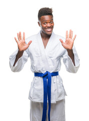 Canvas Print - Young african american man over isolated background wearing kimono showing and pointing up with fingers number ten while smiling confident and happy.