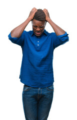 Sticker - Young african american man over isolated background suffering from headache desperate and stressed because pain and migraine. Hands on head.