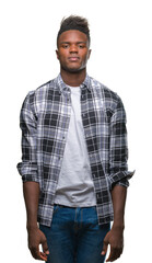 Poster - Young african american man over isolated background with serious expression on face. Simple and natural looking at the camera.