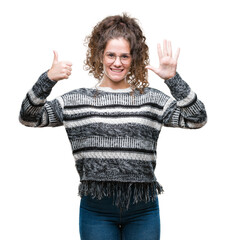 Wall Mural - Beautiful brunette curly hair young girl wearing glasses over isolated background showing and pointing up with fingers number six while smiling confident and happy.