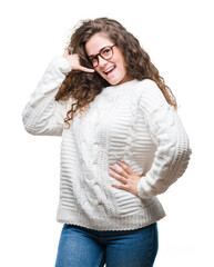 Sticker - Beautiful brunette curly hair young girl wearing winter sweater over isolated background smiling doing phone gesture with hand and fingers like talking on the telephone. Communicating concepts.