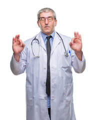 Sticker - Handsome senior doctor man over isolated background relax and smiling with eyes closed doing meditation gesture with fingers. Yoga concept.