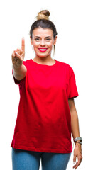 Wall Mural - Young beautiful woman over isolated background showing and pointing up with finger number one while smiling confident and happy.