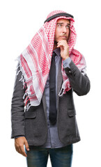 Sticker - Young handsome arabian man with long hair wearing keffiyeh over isolated background with hand on chin thinking about question, pensive expression. Smiling with thoughtful face. Doubt concept.