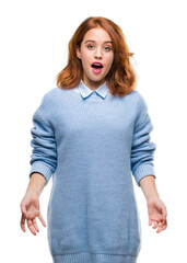 Poster - Young beautiful woman over isolated background wearing winter sweater afraid and shocked with surprise expression, fear and excited face.