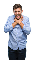 Canvas Print - Young handsome man over isolated background shouting and suffocate because painful strangle. Health problem. Asphyxiate and suicide concept.