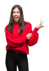 Sticker - Young beautiful hispanic wearing red sweater smiling with happy face winking at the camera doing victory sign. Number two.