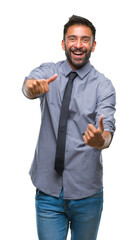 Wall Mural - Adult hispanic business man over isolated background approving doing positive gesture with hand, thumbs up smiling and happy for success. Looking at the camera, winner gesture.