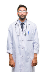 Poster - Adult hispanic doctor man over isolated background with serious expression on face. Simple and natural looking at the camera.