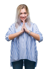 Sticker - Young blonde woman over isolated background praying with hands together asking for forgiveness smiling confident.