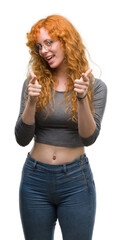 Poster - Young redhead woman pointing fingers to camera with happy and funny face. Good energy and vibes.