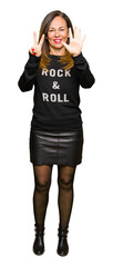 Poster - Beautiful middle age woman wearing rock and roll sweater showing and pointing up with fingers number seven while smiling confident and happy.