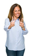 Wall Mural - Beautiful middle age business adult woman over isolated background smiling looking to the camera showing fingers doing victory sign. Number two.