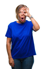 Sticker - Middle age senior hispanic woman over isolated background doing ok gesture shocked with surprised face, eye looking through fingers. Unbelieving expression.